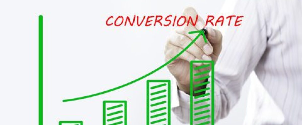"CONVERSION RATE" text with hand of young businessman point on virtual graph green line and bar showing on increasing with background -business, finance, salary, crisis, and development concept